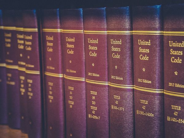 A row of United States Code law books on a library shelf